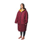 Person wearing a long burgundy coat with yellow lining on a white background