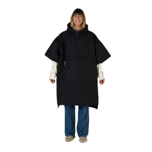 Person wearing a black poncho on a white background